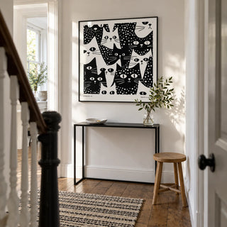 Cat Art Black and White, framed on the wall of a bright narrow hallway in a Victorian terrace with white painted walls and restored timber floorboards