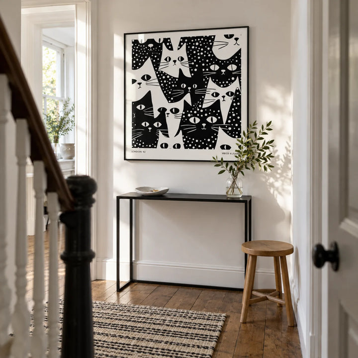 Cat Art Black and White, framed on the wall of a bright narrow hallway in a Victorian terrace with white painted walls and restored timber floorboards