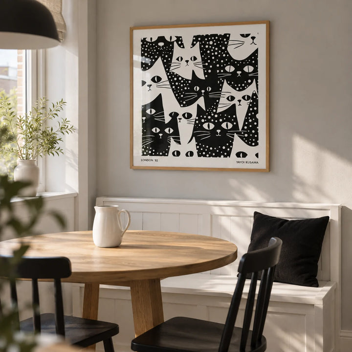Cat Art Black and White, framed on the wall of a modern dining nook in a UK flat with a pale grey wall and white painted bench seating