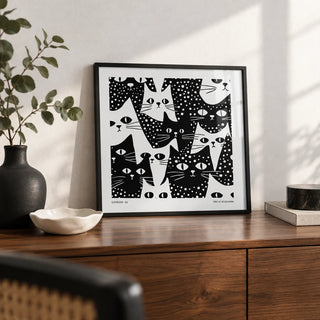 Cat Art Black and White, a small A4 framed print leaning on a walnut sideboard in a living room