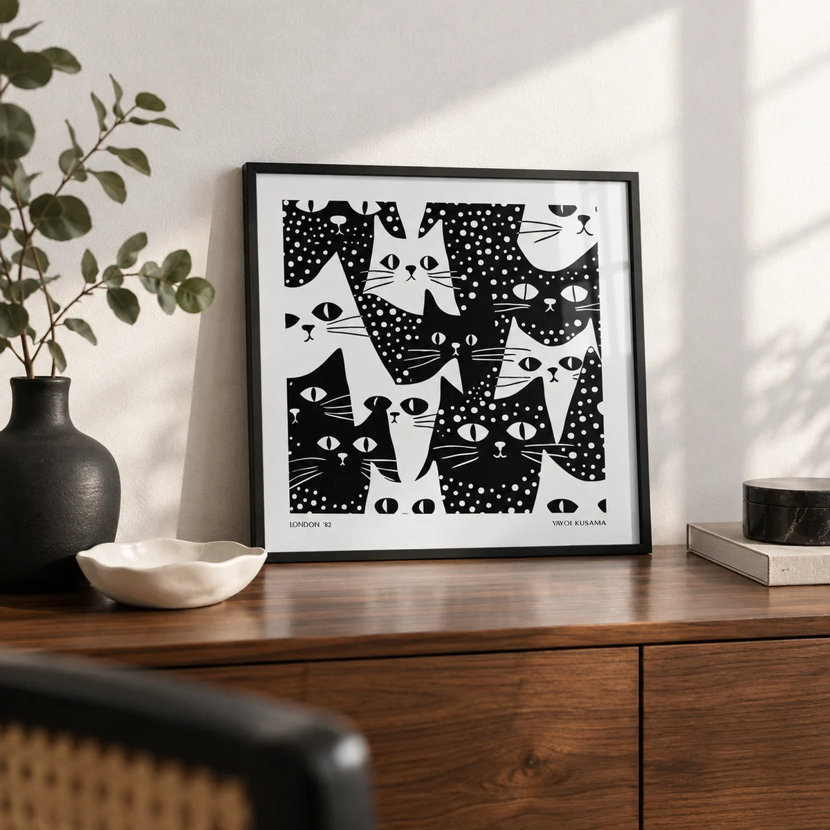 Cat Art Black and White, a small A4 framed print leaning on a walnut sideboard in a living room