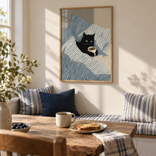 Cat in Bed Print, framed on the wall of a breakfast nook in a kitchen