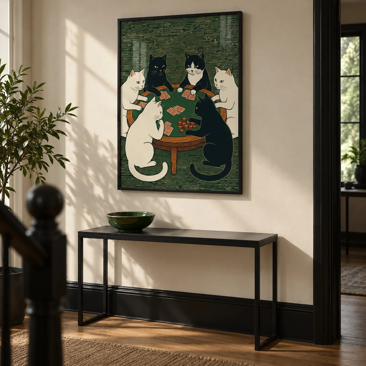Cat Poker Art Print, framed on the wall of a hallway with a cream wall and a black painted skirting