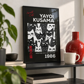 Cats Black Poster, a small A4 framed print leaning on a black metal shelf in a living room