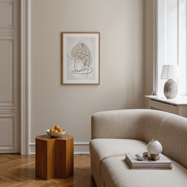 Minimal single-line drawing of seated figure over soft beige and gray shapes