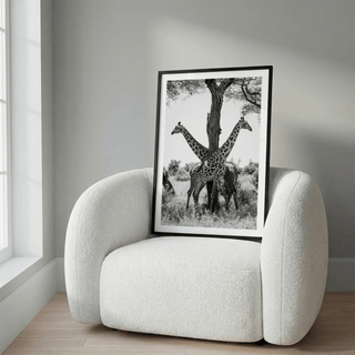 Close-up wildlife poster of two giraffes flanking a tree trunk in monochrome