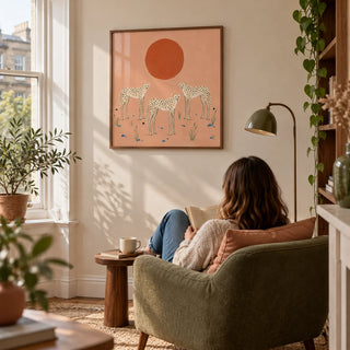 Cheetah Art Print, framed on the wall of a quiet reading corner beside a bay window in a UK flat with a cream wall in a living room