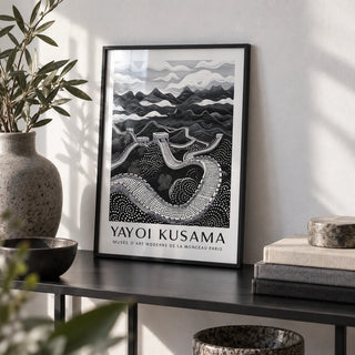 Chinese Wall Art, a small A4 framed print leaning on a black metal shelf in a living room