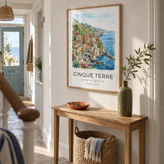 Cinque Terre Art Print, framed on the wall of a bright narrow hallway in a UK seaside terrace with off-white walls and a natural stone floor