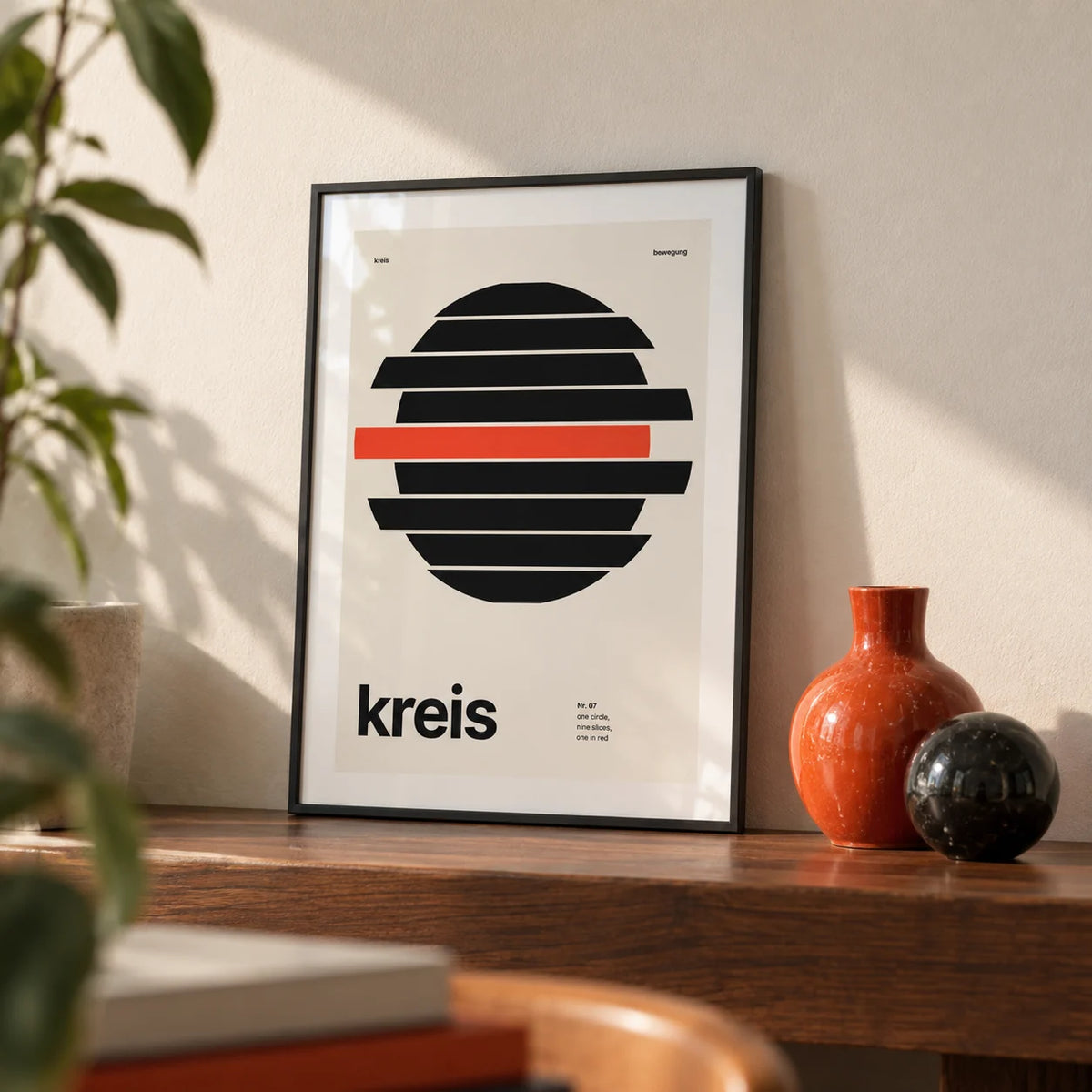 Circle Print, a small A4 framed print leaning on a walnut shelf in a living room