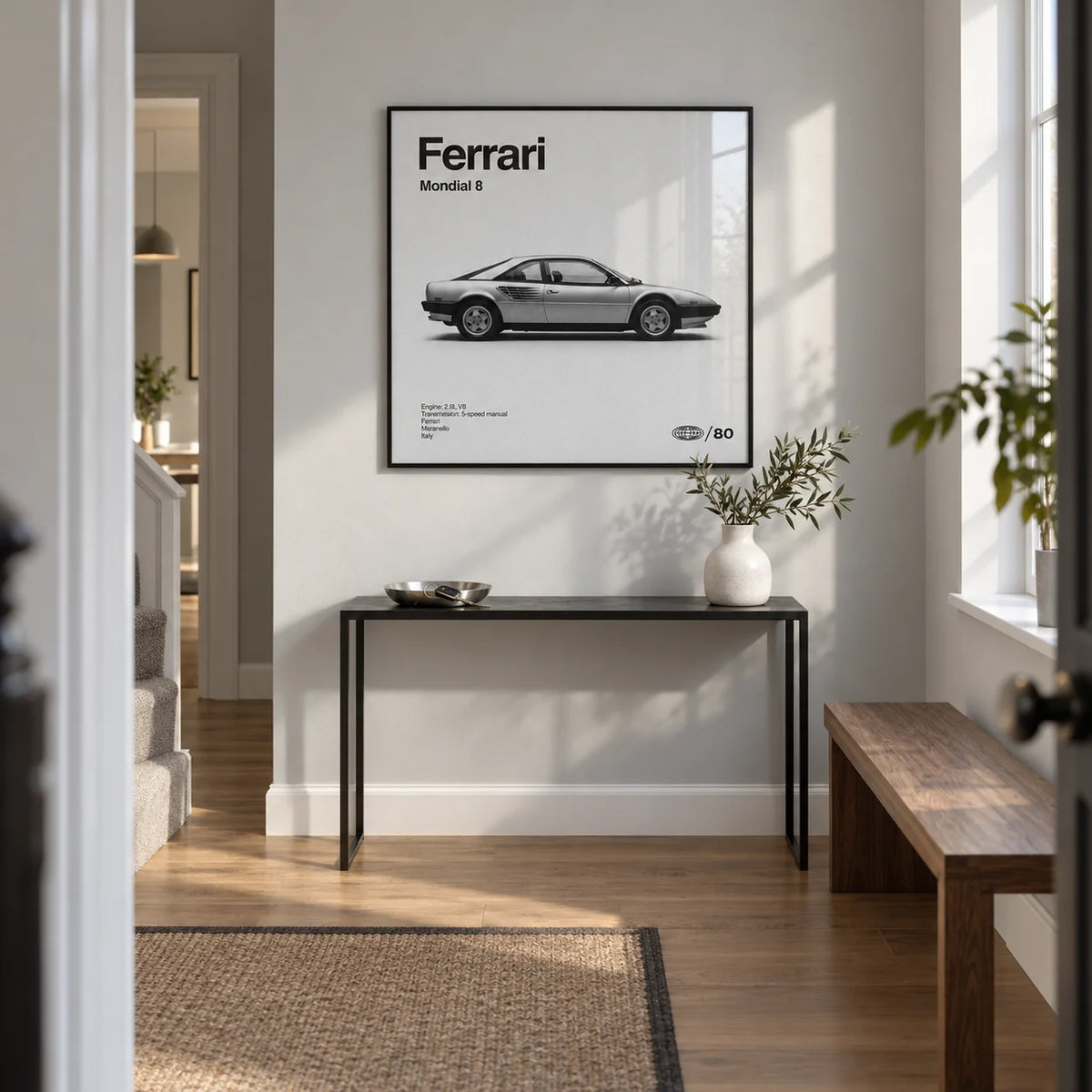 Classic 1980s Italian Coupe Poster, framed on the wall of a bright entrance hallway in a contemporary UK maisonette with a pale grey wall and oak floor