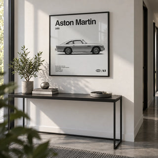 Classic British Grand Tourer Poster, framed on the wall of a crisp modern hallway with a white wall and a grey floor