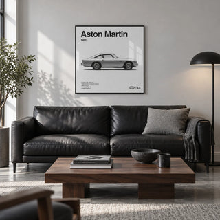 Classic British Grand Tourer Poster, framed on the wall of a design-led city flat living room with a pale grey wall and a polished concrete floor