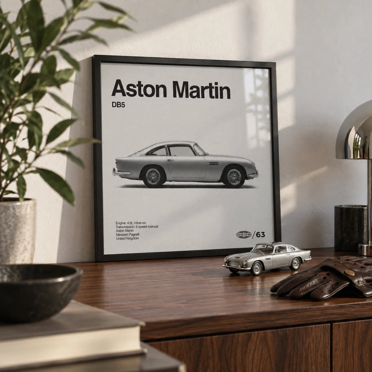 Classic British Grand Tourer Poster, a small A4 framed print leaning on a walnut shelf in a living room