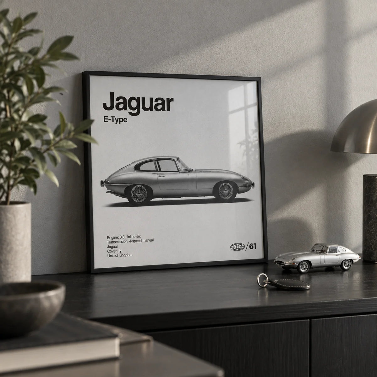 Classic British Sports Car Poster, a small A4 framed print leaning on a black shelf in a living room