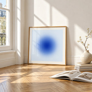 Cobalt Blue Wall Art, framed and leaning on the parquet floor of a bright living room