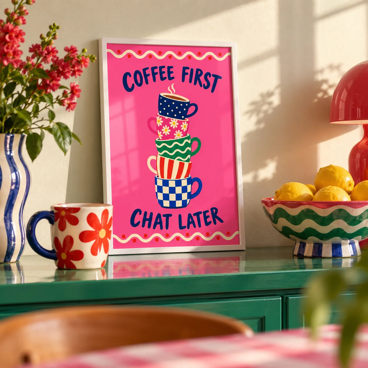 Coffee First Print, a small A4 framed print leaning on a colourful lacquered shelf in a living room