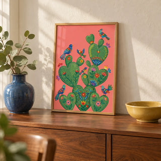 Colorful Cactus Art Print, a small A4 framed print leaning on a walnut sideboard in a living room