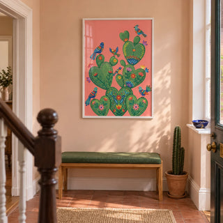 Colorful Cactus Art Print, framed on the wall of a welcoming hallway in a Victorian UK terrace with pale peach plaster walls and plain terracotta floor tiles