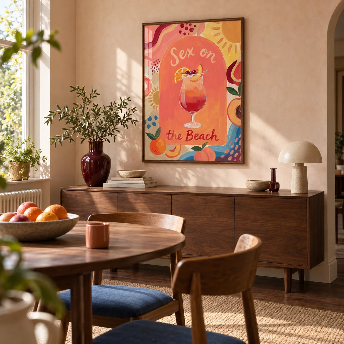 Colorful Drink Poster, framed on the wall of a design-led dining room in a UK terraced home with pale peach plaster walls and a walnut floor