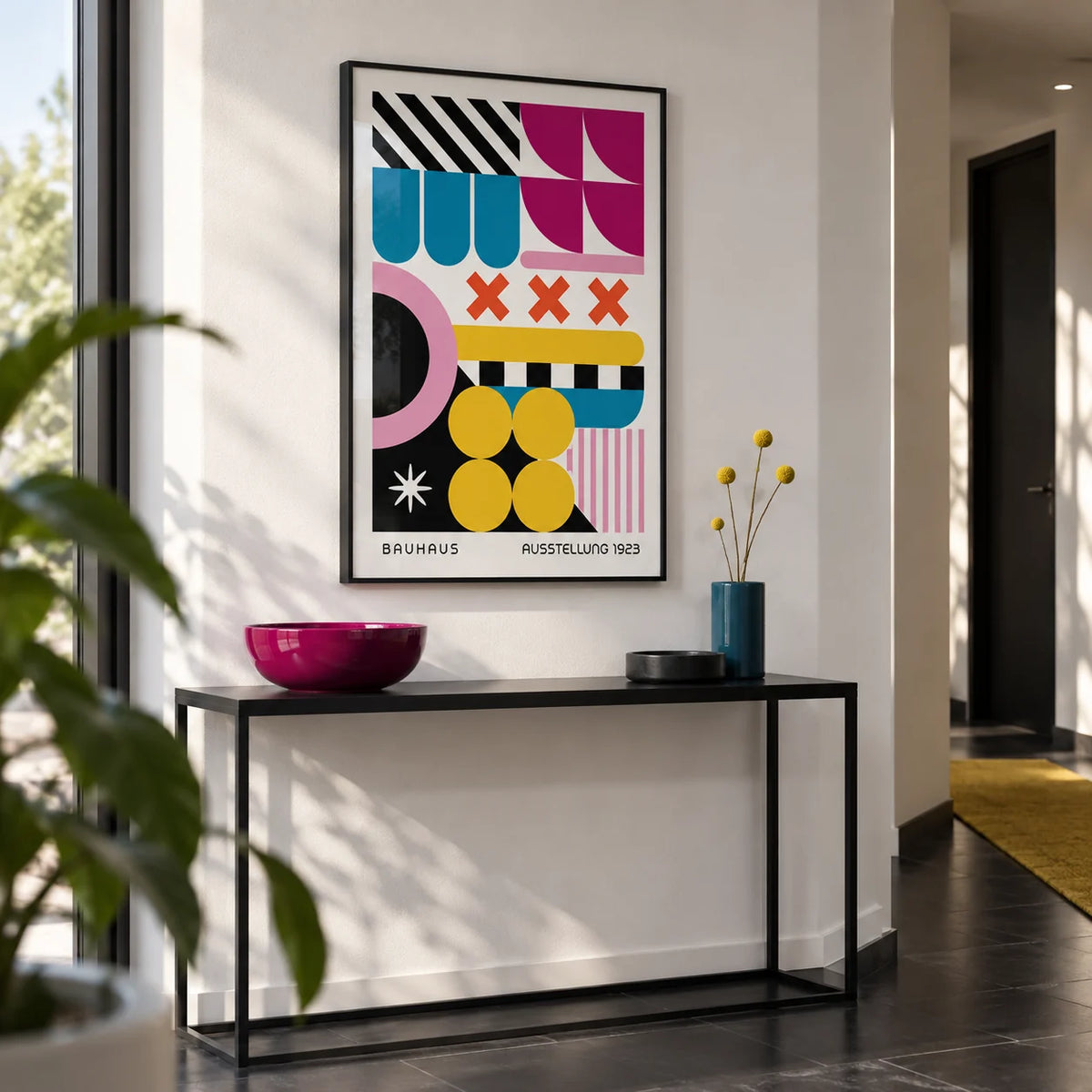 Colorful Prints, framed on the wall of a modern hallway with a white wall and a black floor