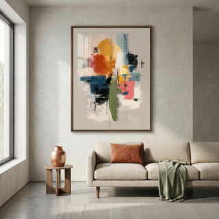 Modern living room with a colorful abstract painting on the wall, a beige sofa, and a wooden side table.