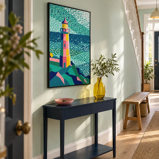 Colourful Lighthouse Print, framed on the wall of a welcoming hallway in a renovated UK terraced house with a pale mint wall and simple oak floorboards