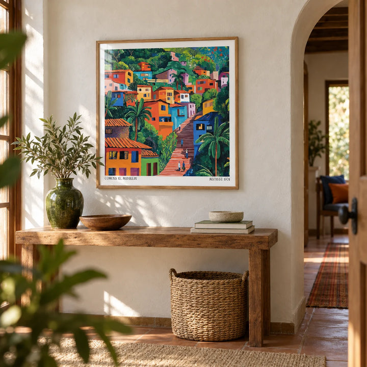 Comuna 13 Art, framed on the wall of a warm hallway with a limewashed white wall and an arched doorway