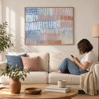 Contemporary Abstract Print, framed on the wall of a calm modern living room with a plain warm white wall