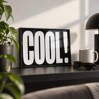 Cool Typography Art, a small A4 framed print leaning on a black shelf in a living room