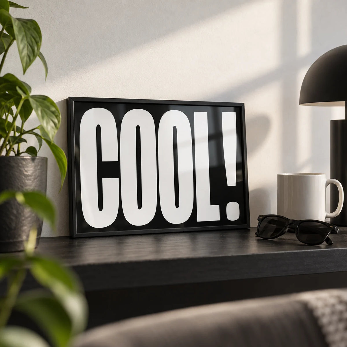 Cool Typography Art, a small A4 framed print leaning on a black shelf in a living room