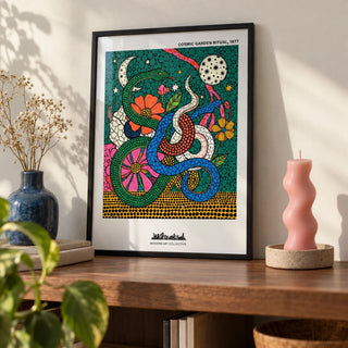 Cosmic Garden Print, a small A4 framed print leaning on a walnut shelf in a living room