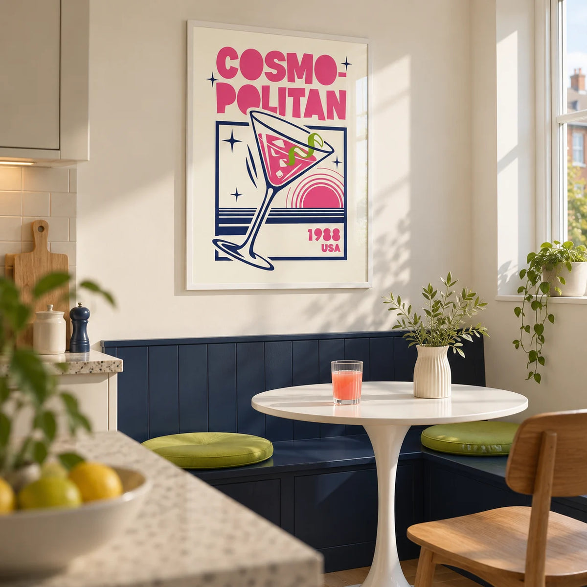 Cosmopolitan Cocktail Art Print, framed on the wall of a compact kitchen breakfast nook in a renovated UK flat with a pale ivory wall and a plain navy built-in bench