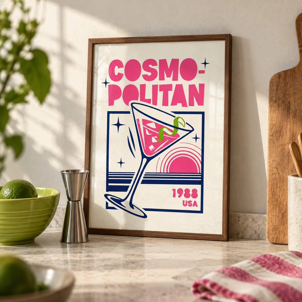 Cosmopolitan Cocktail Art Print, a small A4 framed print leaning on a pale stone kitchen worktop
