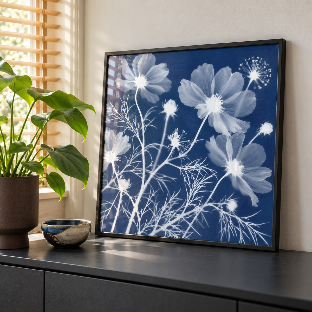 Cosmos Cyanotype Print styled on a black sideboard (frame not included)
