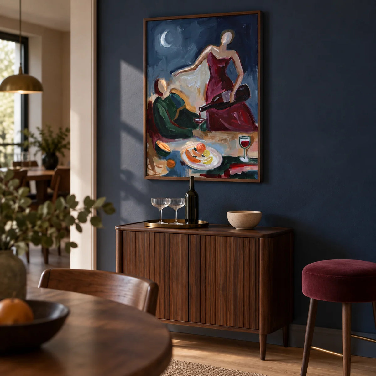 Couple Dinner Wall Art, framed on the wall of a small home bar corner in an open-plan dining room with a muted navy wall and pale oak flooring