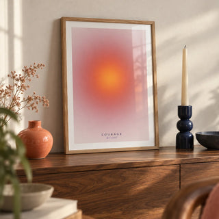 Courage Poster, a small A4 framed print leaning on a walnut sideboard in a living room