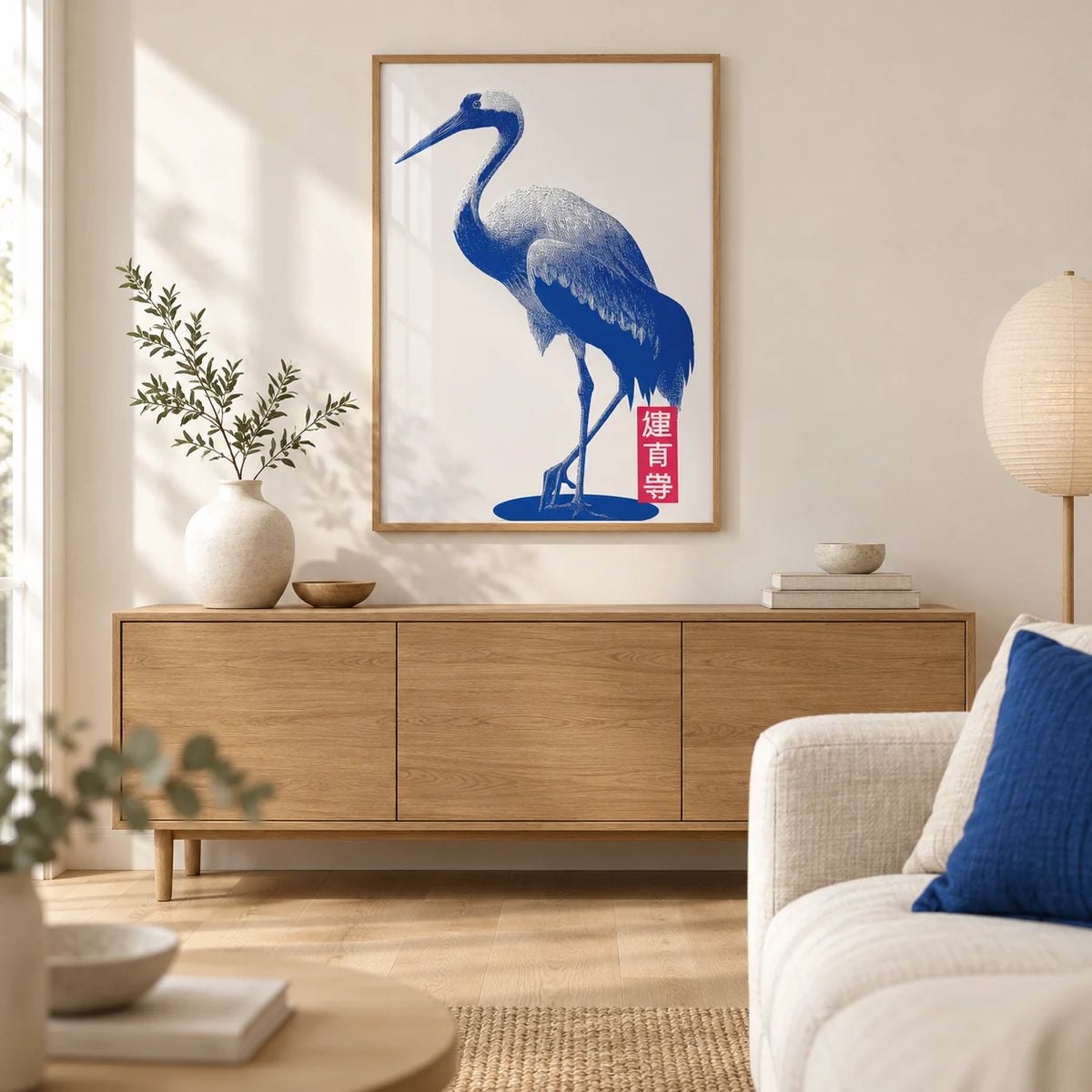 Crane Wall Art, framed on the wall of a calm Japandi living room with a warm white wall and a pale oak floor