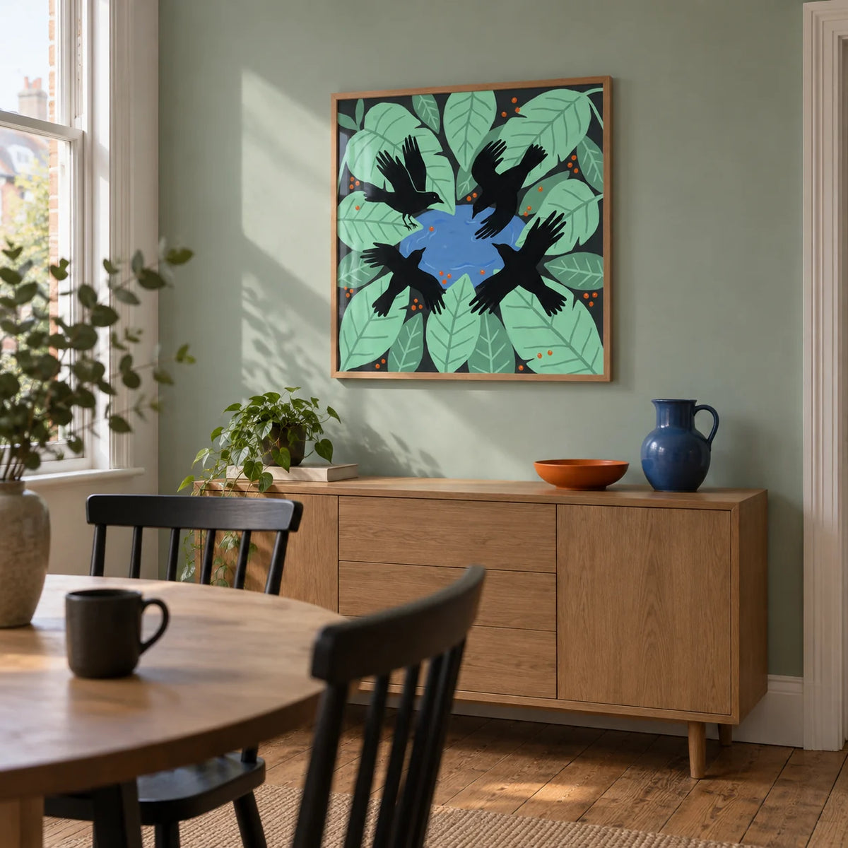 Crows Art Print, framed on the wall of a modern dining room in a British terraced house with a muted mint green wall and oak floorboards