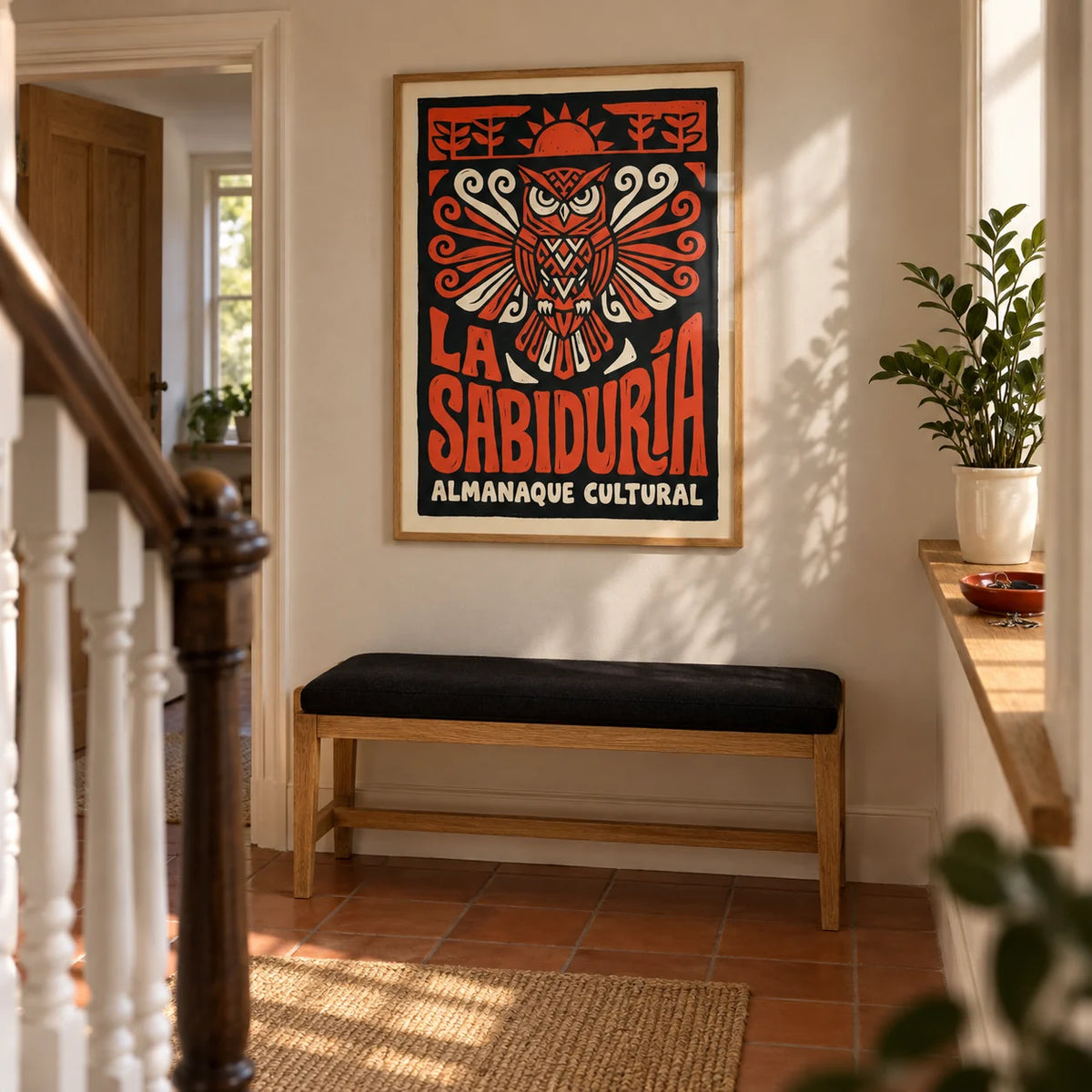 Cultural Owls Poster, framed on the wall of a welcoming hallway in a UK terraced house with warm white plaster walls and terracotta floor tiles