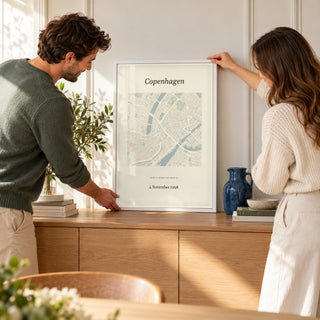 Anniversary Map Print in a couple arranging their home, white frame