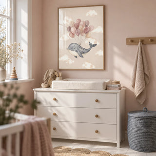 Moon And Sun Print, framed on the wall of a compact nursery changing area in a UK first family flat with pale blush walls and a white painted floor