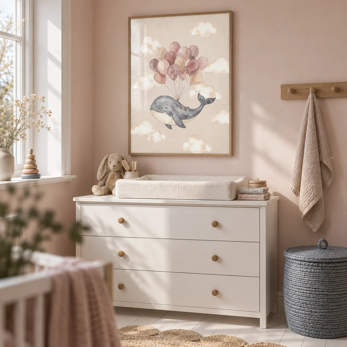 Moon And Sun Print, framed on the wall of a compact nursery changing area in a UK first family flat with pale blush walls and a white painted floor
