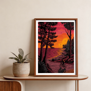 Bicycle Adventure Print poster of a lone cyclist on a curving coastal road with a large sun reflection