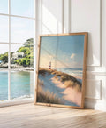 Coastal print featuring lighthouse and grassy beach landscape in warm evening light.