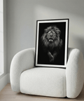Centered black and white lion poster showing intense gaze and textured fur