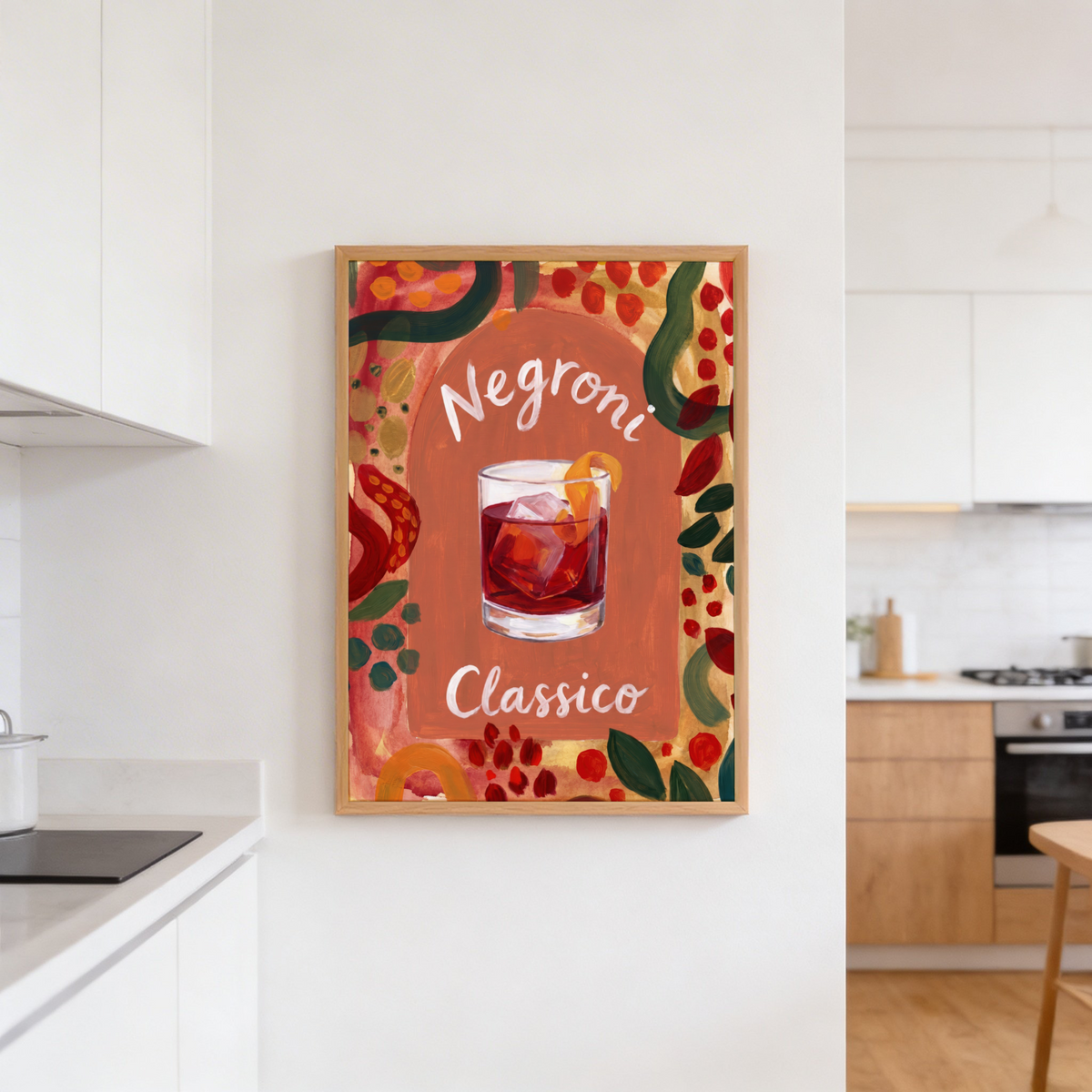 Kitchen shelf decor showing cocktail poster beside emerald glass bottles