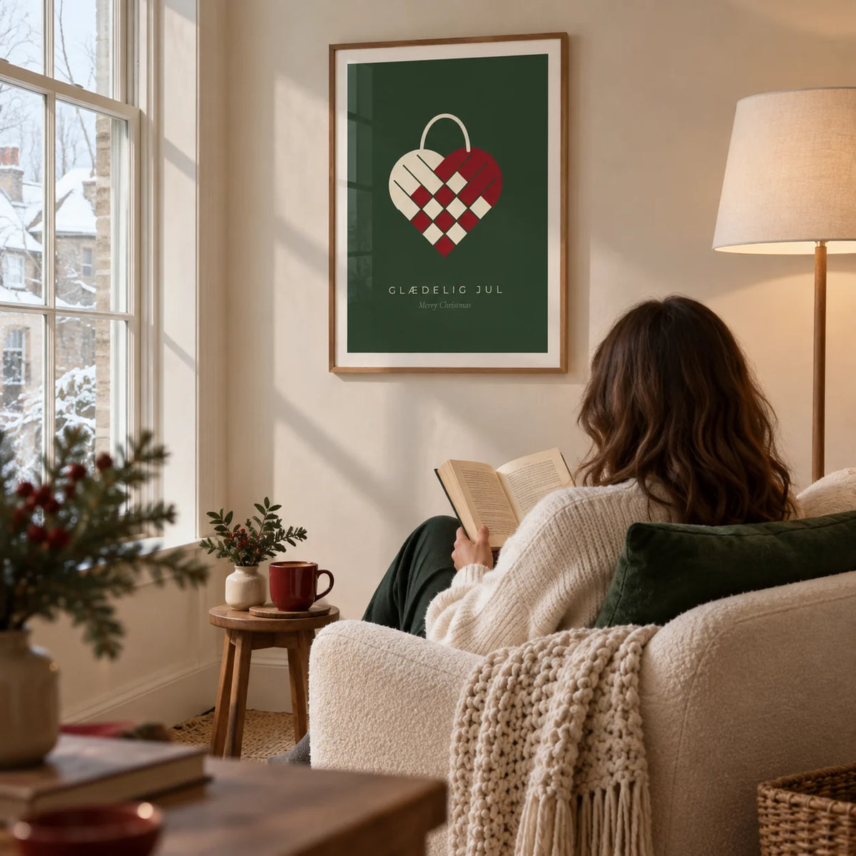 Danish Christmas Print, framed on the wall of a quiet winter reading corner in a UK home with a cream wall and a tall window in a living room