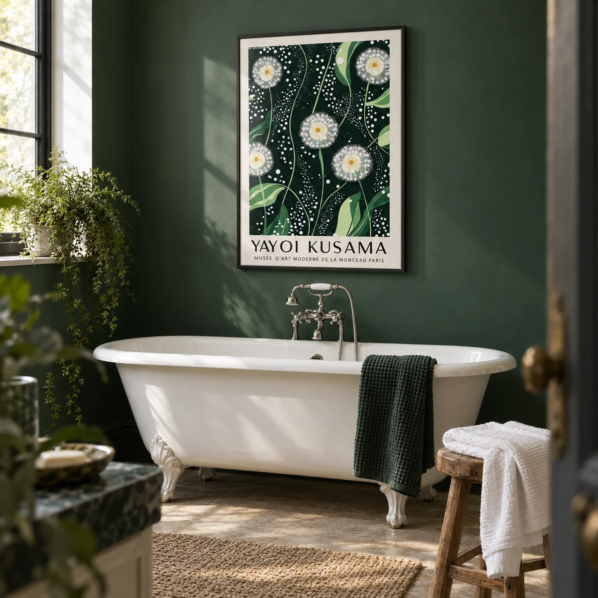 Yayoi Kusama Dandelions: Dark Green Wall Art, framed on the wall of a calm bathroom with a deep green painted wall and a white roll-top bath