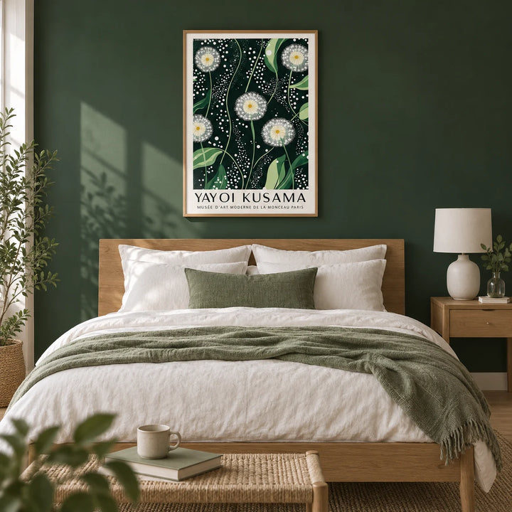 Yayoi Kusama Dandelions: Dark Green Wall Art, framed on the wall of a calm bedroom with a deep forest green painted wall and a pale oak floor